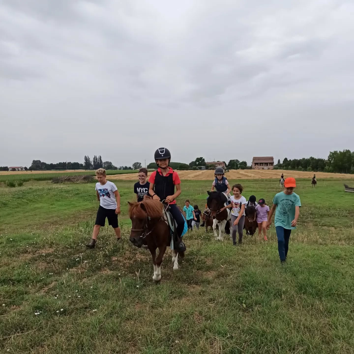 Bambini e ragazzi durante i campi estivi del Circolo Ippico Tara mentre passeggiano con i pony